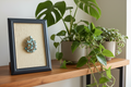 Framed brooch with turquoise stones on a textured beige background